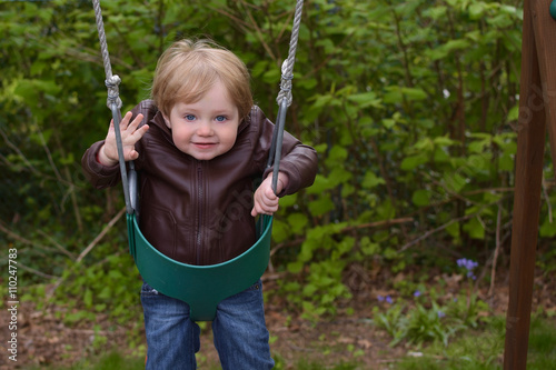 young toddler boy on swing