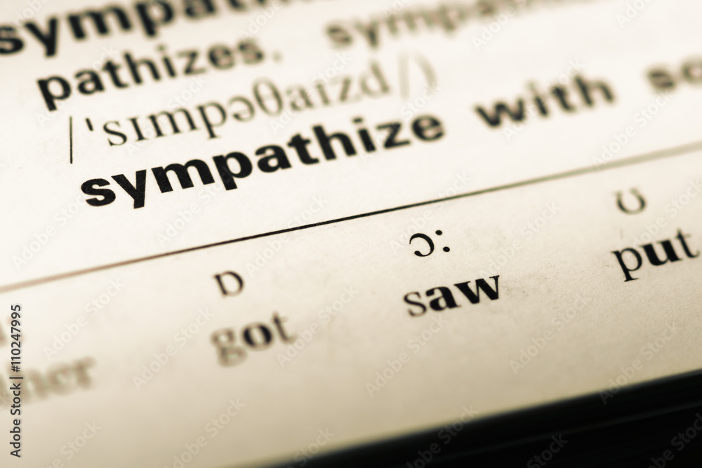 Close up of old English dictionary page with word sympathize wit Close up of old English dictionary page with word sympathize wit