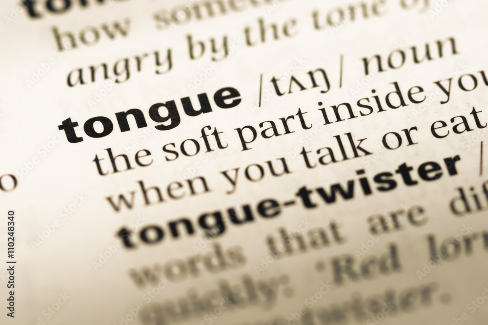 Close up of old English dictionary page with word tongue Close up of old English dictionary page with word tongue