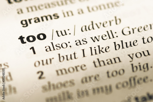 Close up of old English dictionary page with word too