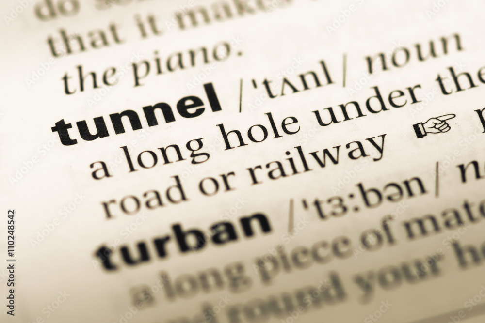Close up of old English dictionary page with word tunnel Close up of old English dictionary page with word tunnel