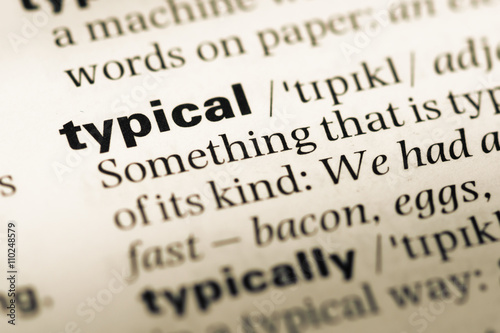 Close up of old English dictionary page with word typical