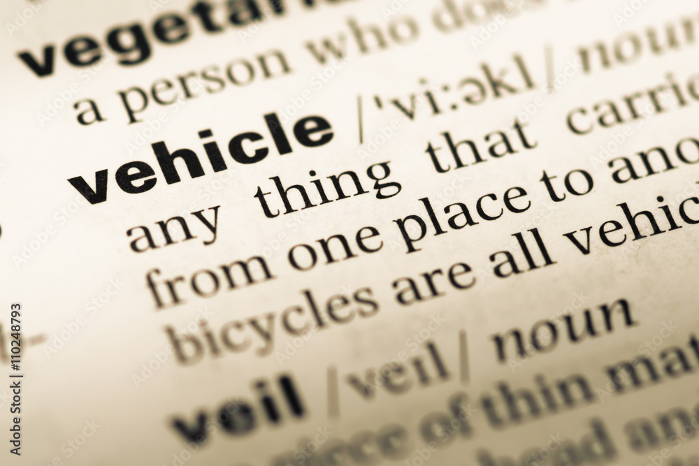 Close up of old English dictionary page with word vehicle