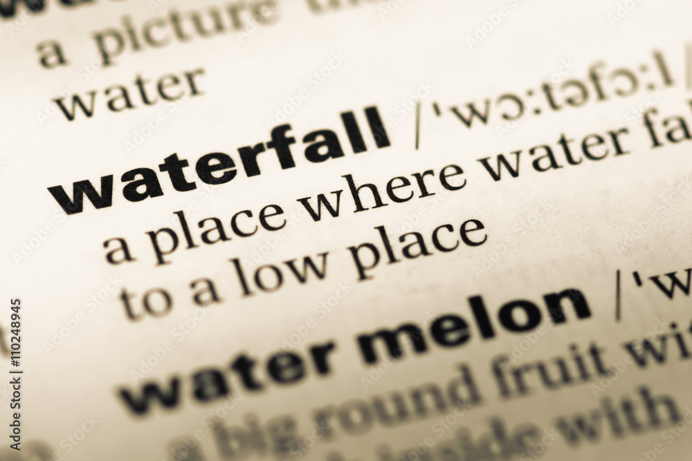 Close up of old English dictionary page with word waterfall Close up of old English dictionary page with word waterfall
