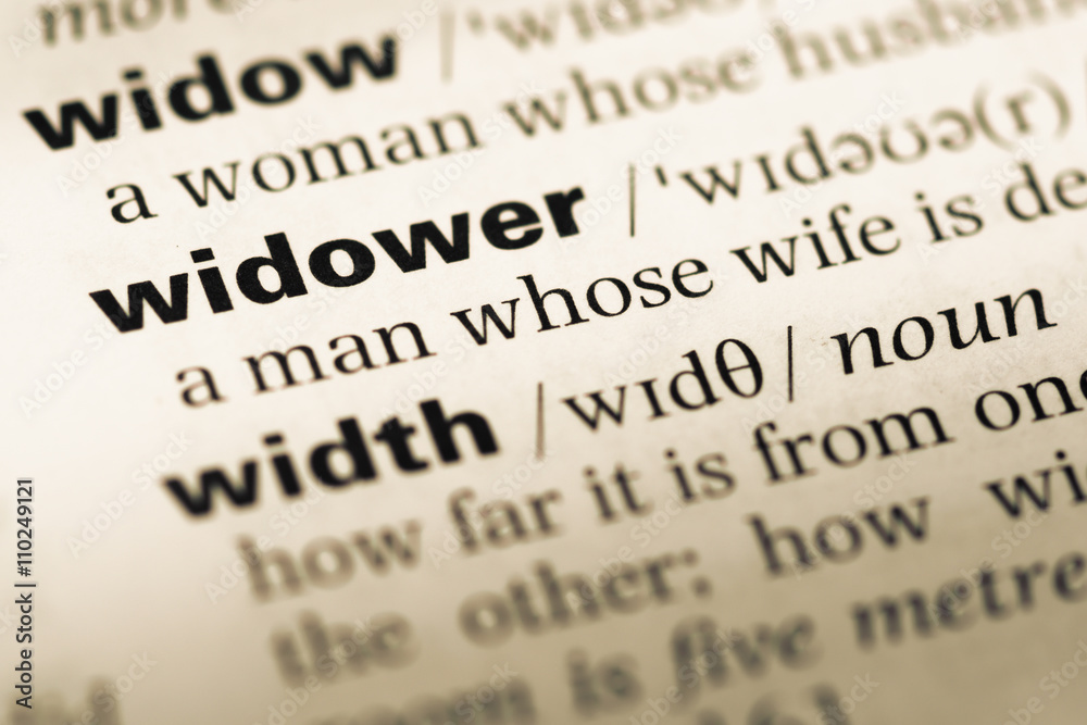 Close up of old English dictionary page with word widower