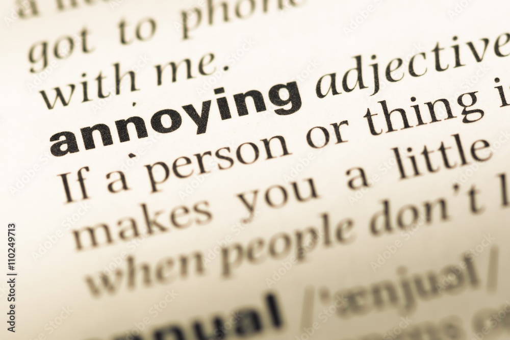 Close up of old English dictionary page with word annoying Close up of old English dictionary page with word annoying