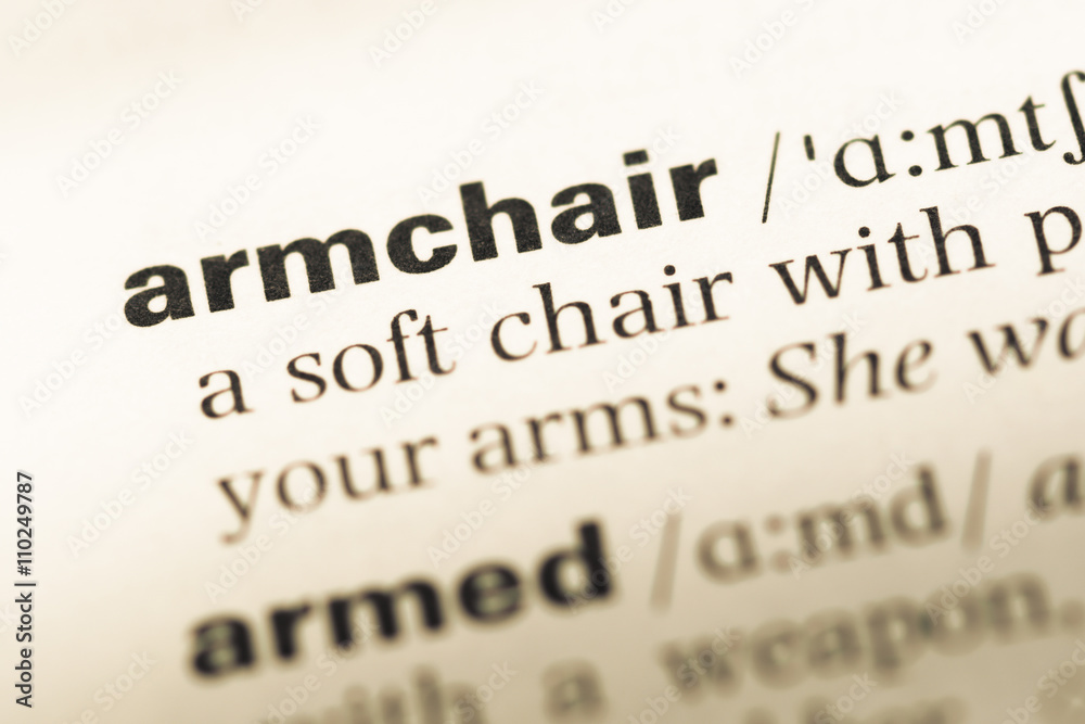 Close up of old English dictionary page with word armchair Close up of old English dictionary page with word armchair