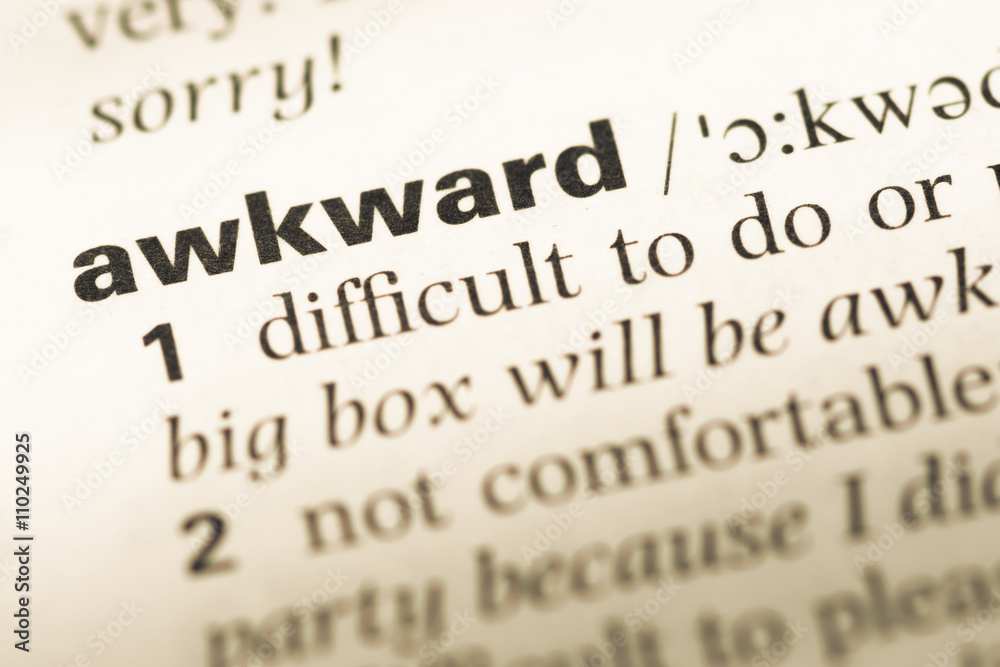 Close up of old English dictionary page with word awkward Close up of old English dictionary page with word awkward