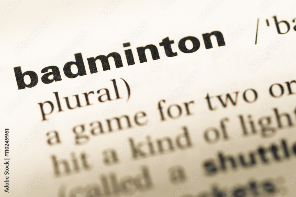 Close up of old English dictionary page with word badminton Close up of old English dictionary page with word badminton