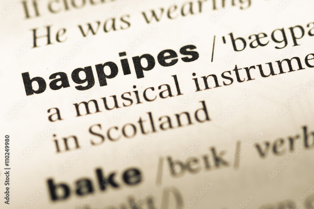 Close up of old English dictionary page with word bagpipes Close up of old English dictionary page with word bagpipes