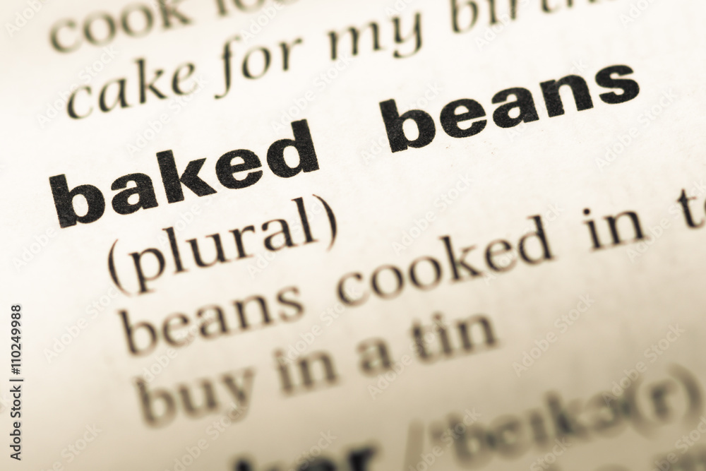 Close up of old English dictionary page with word baked beans Close up of old English dictionary page with word baked beans