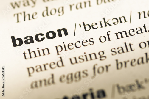 Close up of old English dictionary page with word bacon