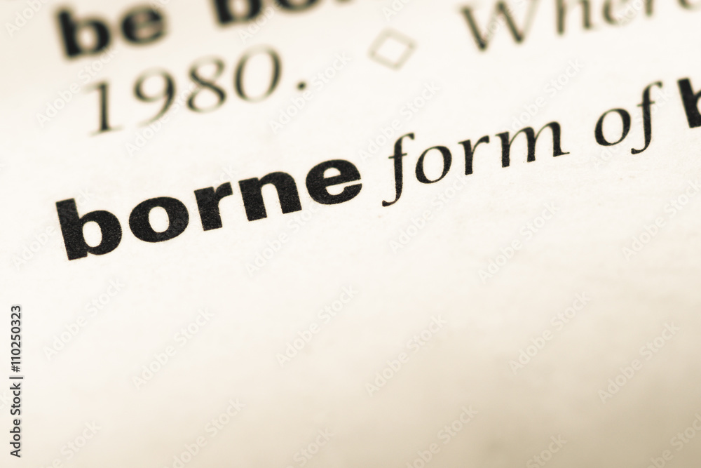 Close up of old English dictionary page with word borne Close up of old English dictionary page with word borne