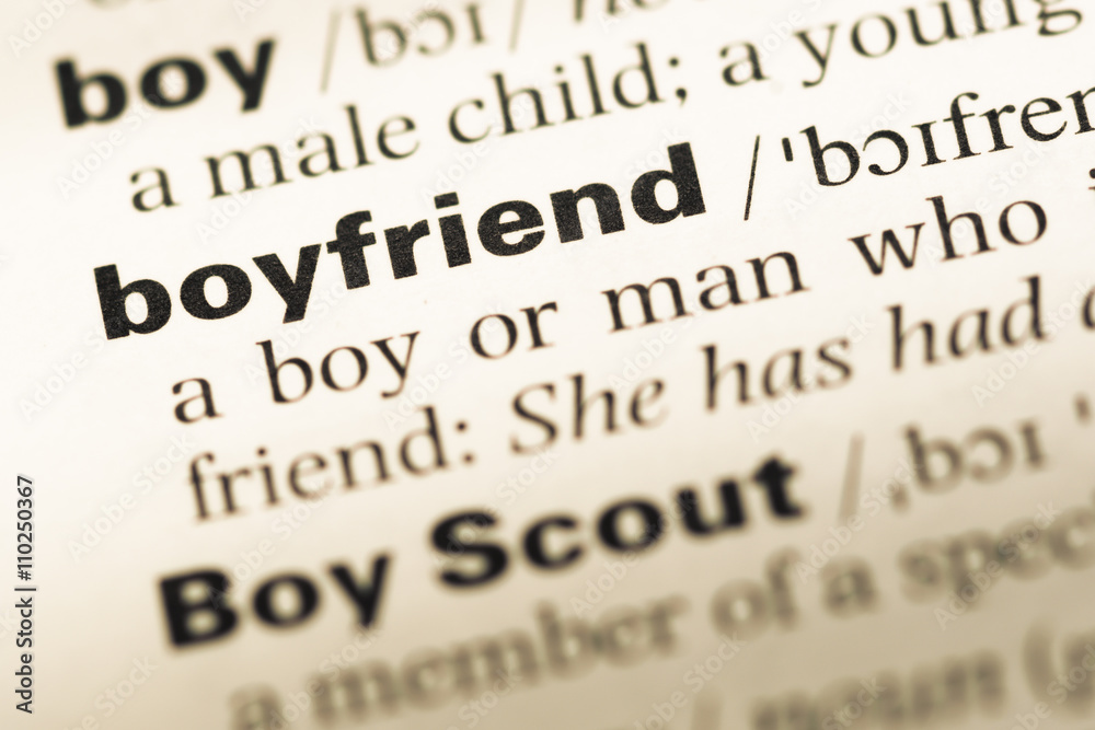Close up of old English dictionary page with word boyfriend Close up of old English dictionary page with word boyfriend