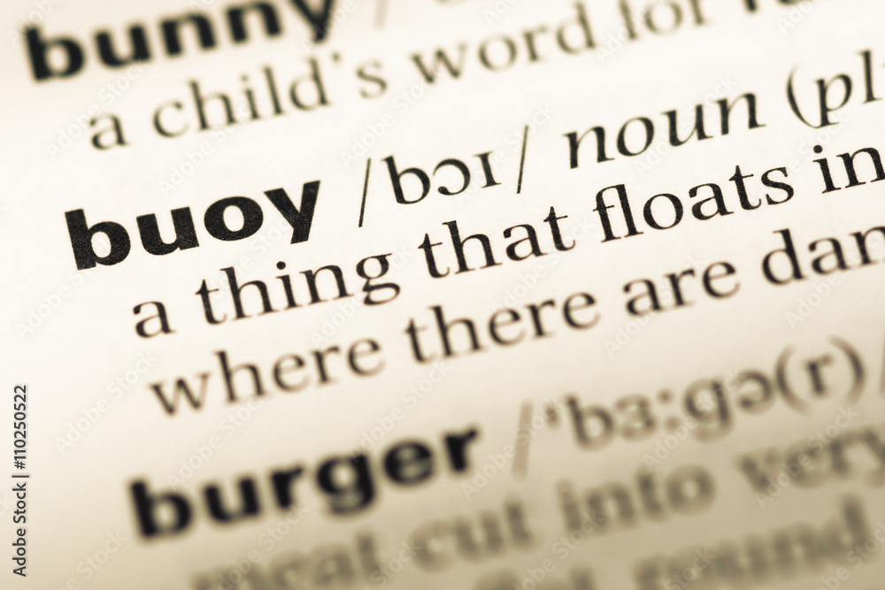 Obraz premium Close up of old English dictionary page with word buoy