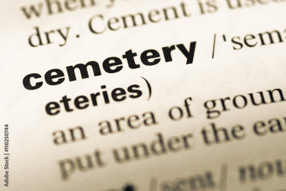 Close up of old English dictionary page with word cemetery Close up of old English dictionary page with word cemetery
