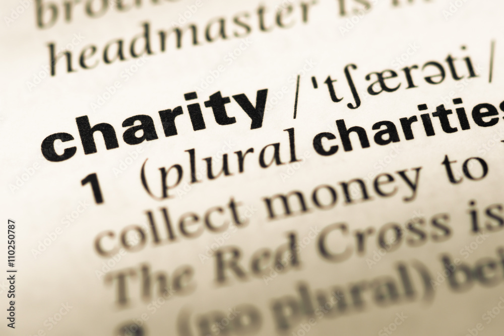 Close up of old English dictionary page with word charity Close up of old English dictionary page with word charity