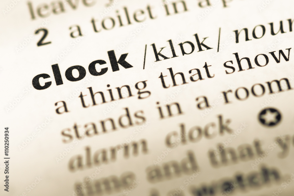 Close up of old English dictionary page with word clock Close up of old English dictionary page with word clock