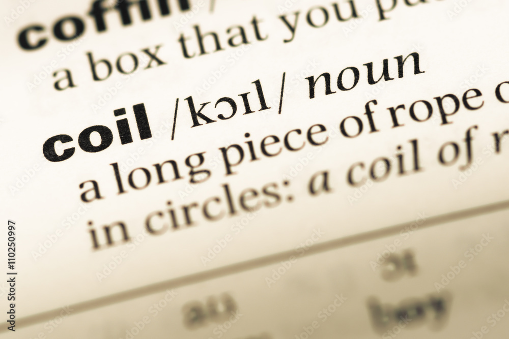 Close up of old English dictionary page with word coil Close up of old English dictionary page with word coil