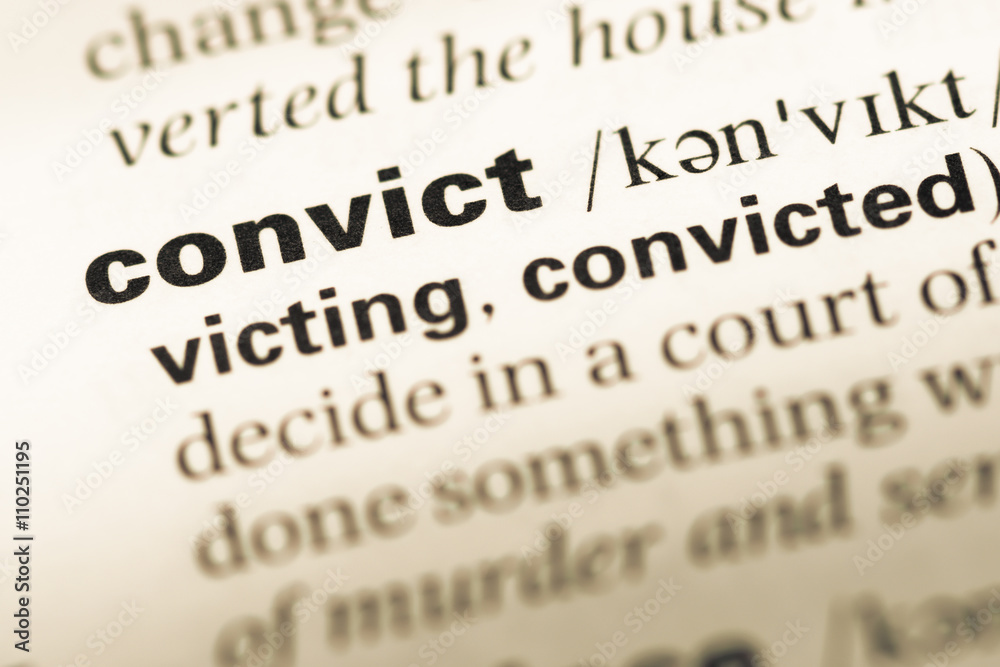 Obraz premium Close up of old English dictionary page with word convict