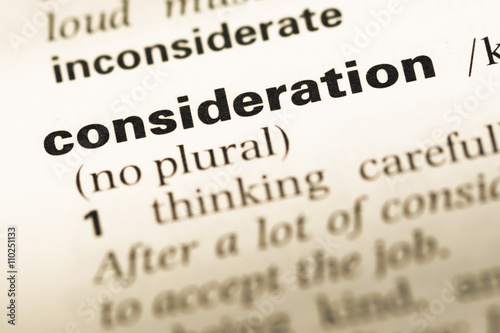 Close up of old English dictionary page with word consideration