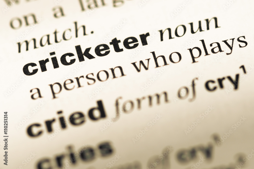 Close up of old English dictionary page with word cricketer Close up of old English dictionary page with word cricketer