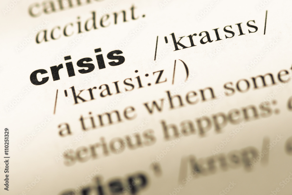 Close up of old English dictionary page with word crisis Close up of old English dictionary page with word crisis