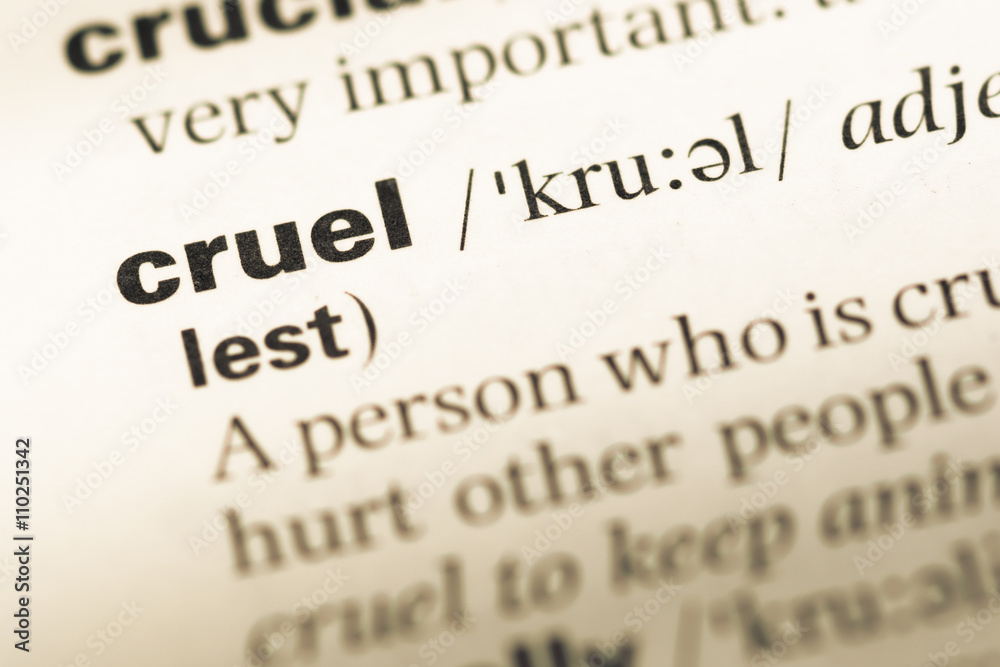 Close up of old English dictionary page with word cruel Close up of old English dictionary page with word cruel