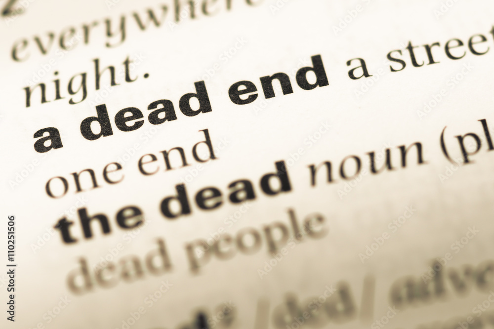 Close up of old English dictionary page with word a dead end Close up of old English dictionary page with word a dead end