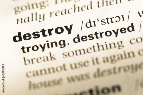 Φωτογραφία Close up of old English dictionary page with word destroy