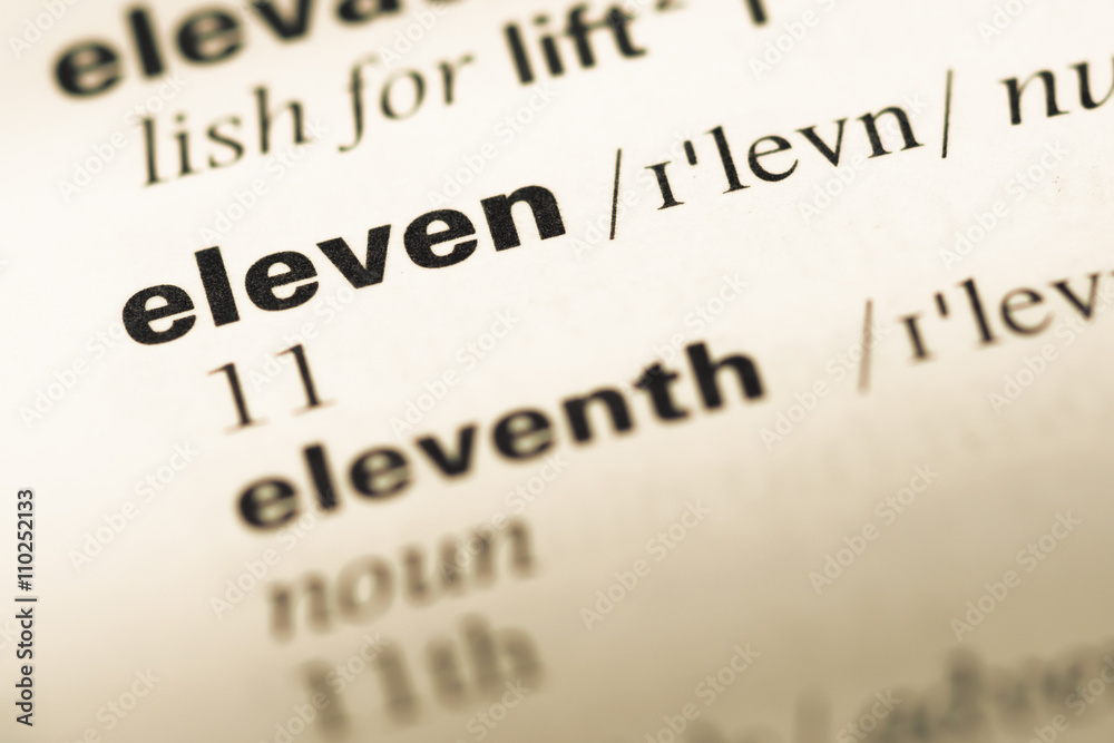 Close up of old English dictionary page with word eleven Close up of old English dictionary page with word eleven