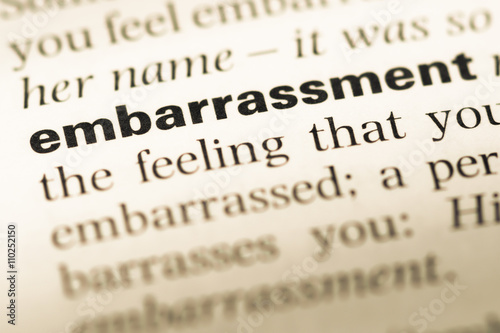 Close up of old English dictionary page with word embarrassment