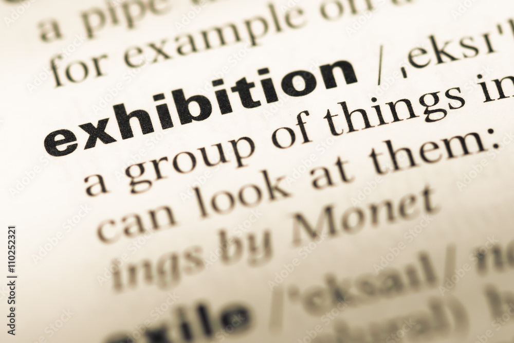 Close up of old English dictionary page with word exhibition Close up of old English dictionary page with word exhibition