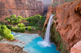 A view of Havasu Falls from the hillside above the falls. The turquoise colored water flowing in to the pool below is surreal and one of a kind in the desert of Arizona