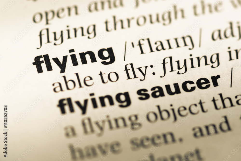 Close up of old English dictionary page with word flying Close up of old English dictionary page with word flying