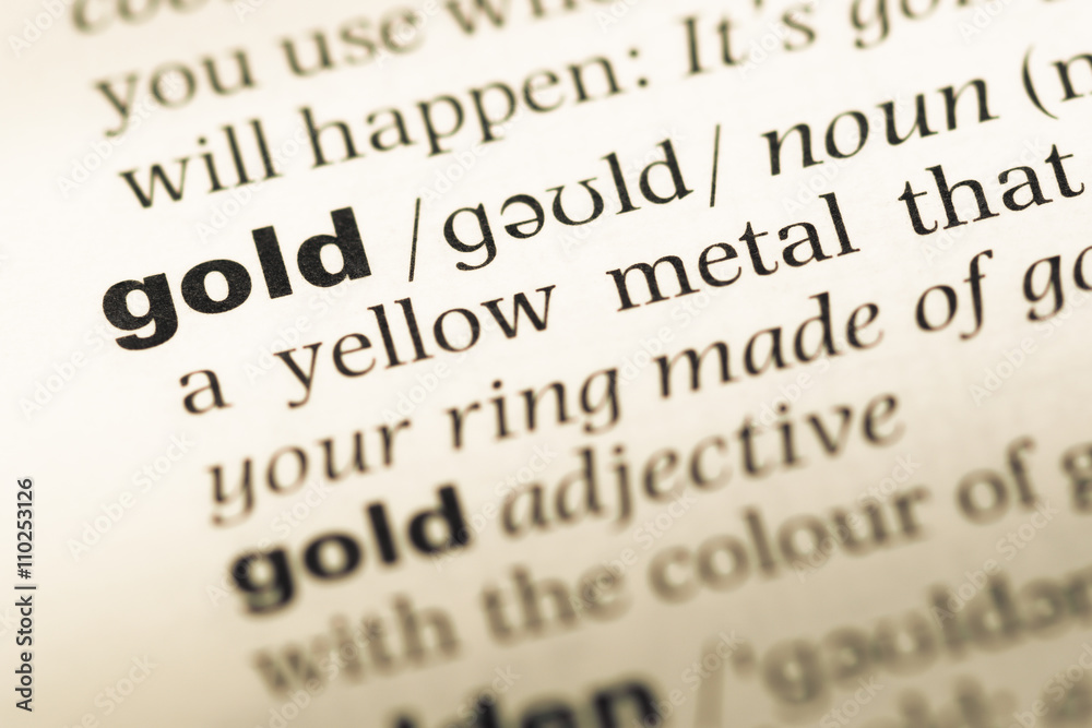 Obraz premium Close up of old English dictionary page with word gold