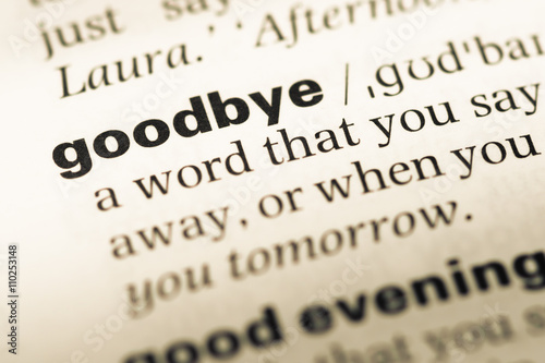 Close up of old English dictionary page with word goodbye photo