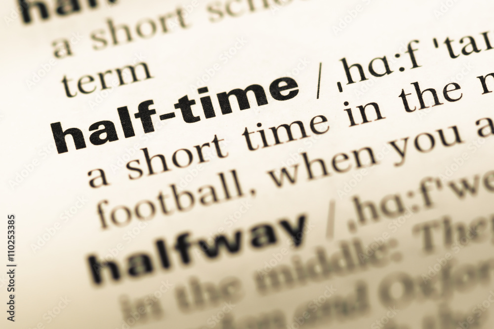 Close up of old English dictionary page with word half time Close up of old English dictionary page with word half time