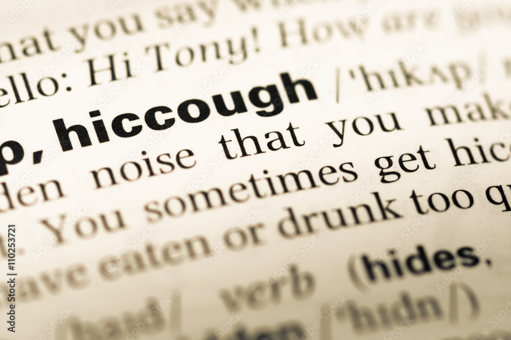 Close up of old English dictionary page with word hiccough