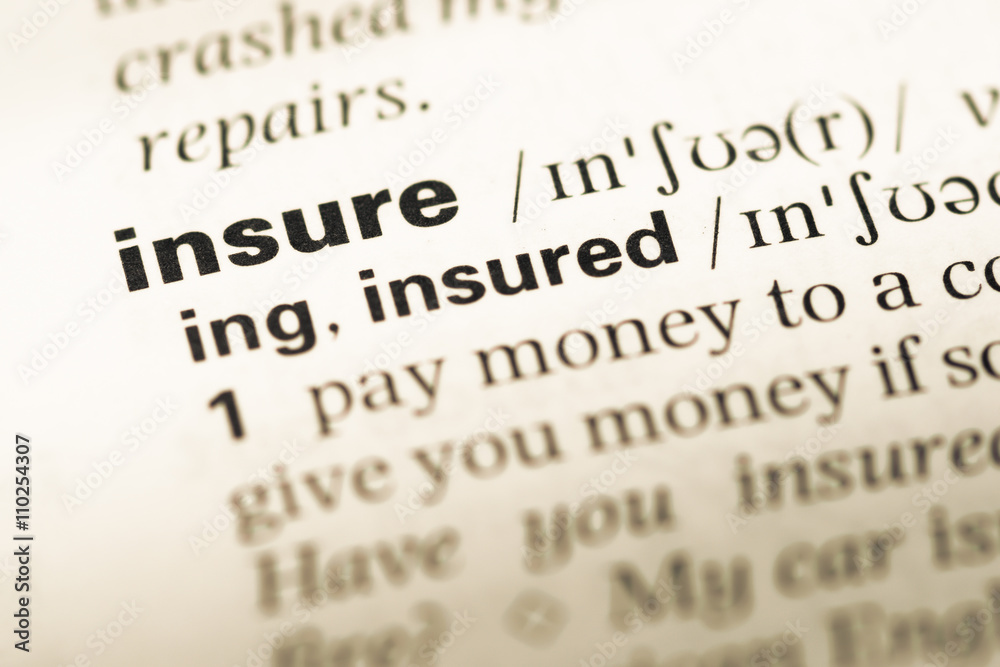 Close up of old English dictionary page with word insure Close up of old English dictionary page with word insure