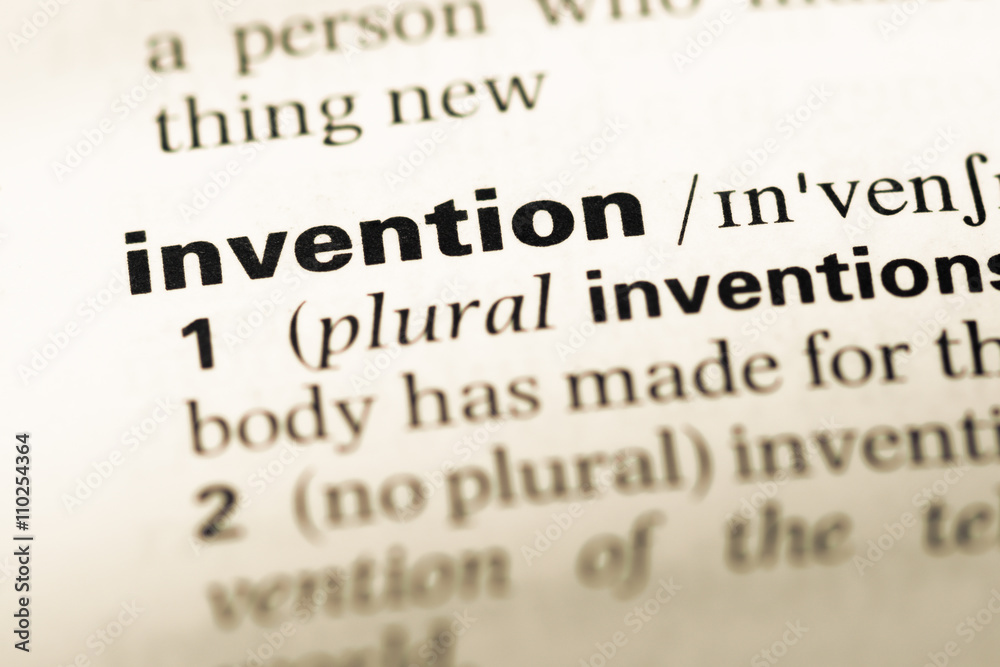 Close up of old English dictionary page with word invention Close up of old English dictionary page with word invention