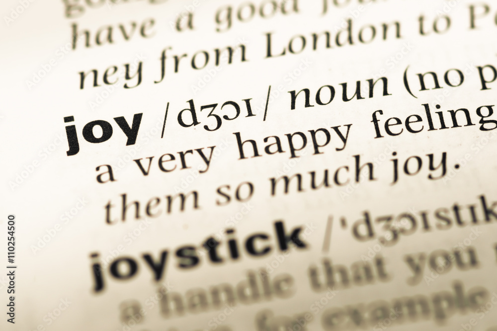 Close up of old English dictionary page with word joy Close up of old English dictionary page with word joy