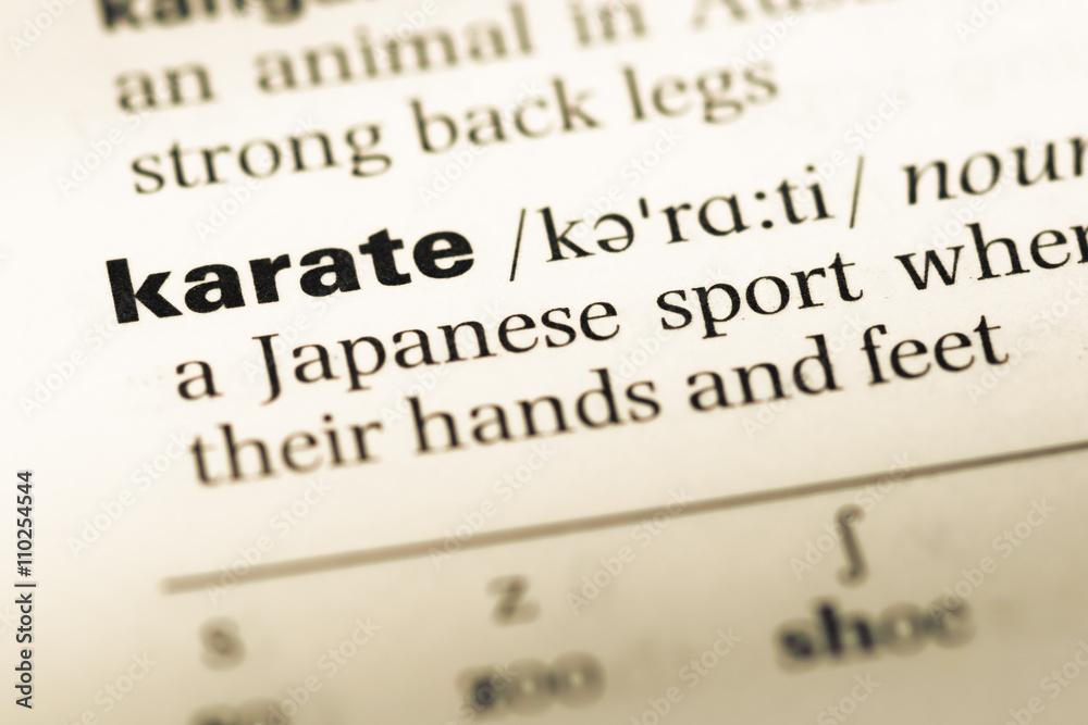 Close up of old English dictionary page with word karate Close up of old English dictionary page with word karate