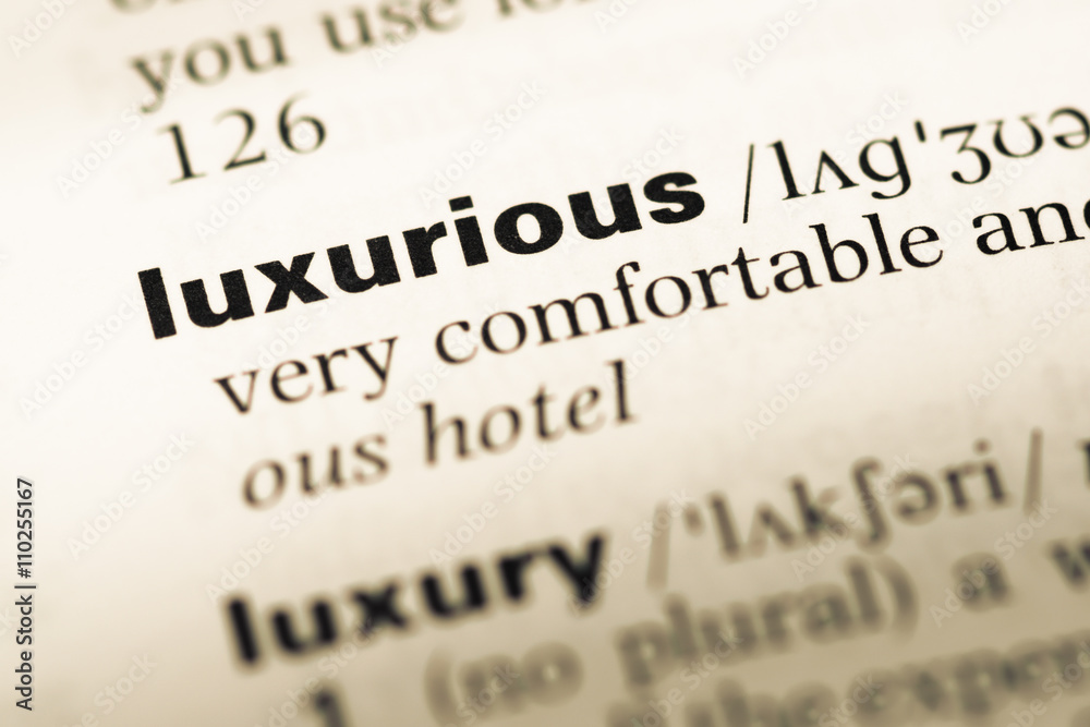 Close up of old English dictionary page with word luxurious Close up of old English dictionary page with word luxurious