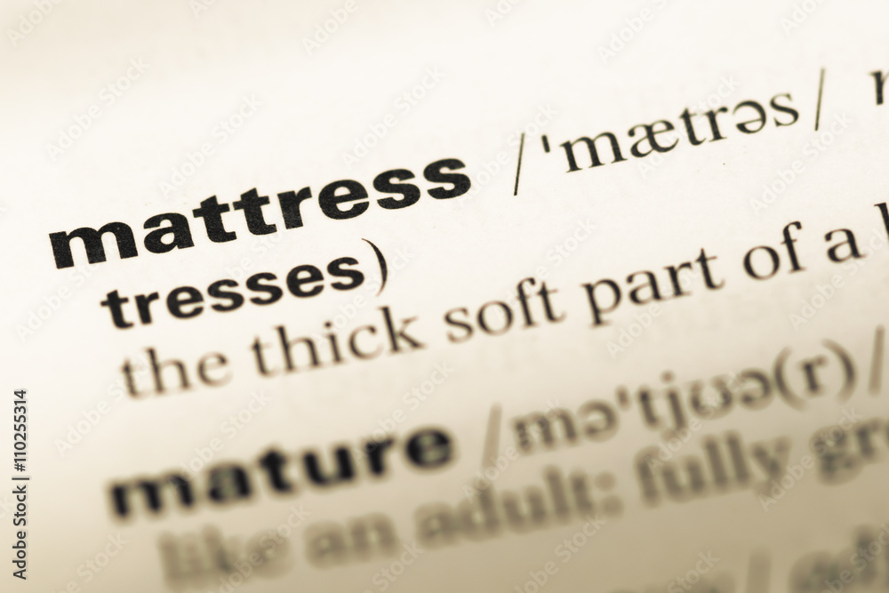 Close up of old English dictionary page with word mattress Close up of old English dictionary page with word mattress