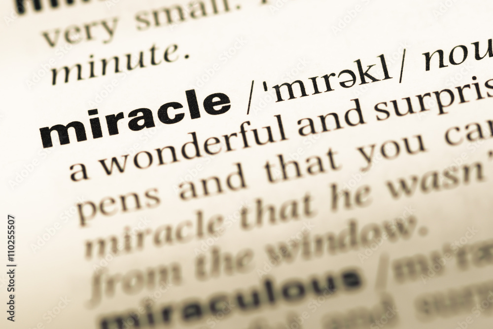 Close up of old English dictionary page with word miracle Close up of old English dictionary page with word miracle
