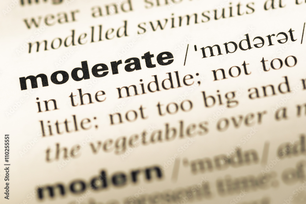 Close up of old English dictionary page with word moderate Close up of old English dictionary page with word moderate