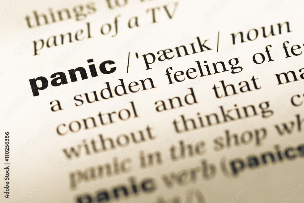 Close up of old English dictionary page with word panic Close up of old English dictionary page with word panic
