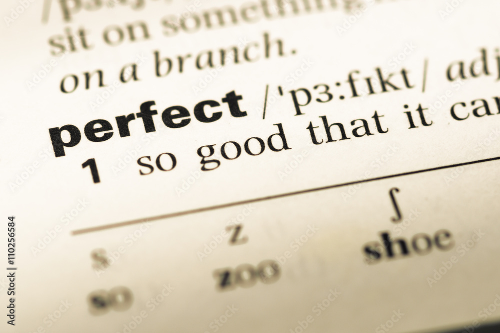 Close up of old English dictionary page with word perfect Close up of old English dictionary page with word perfect