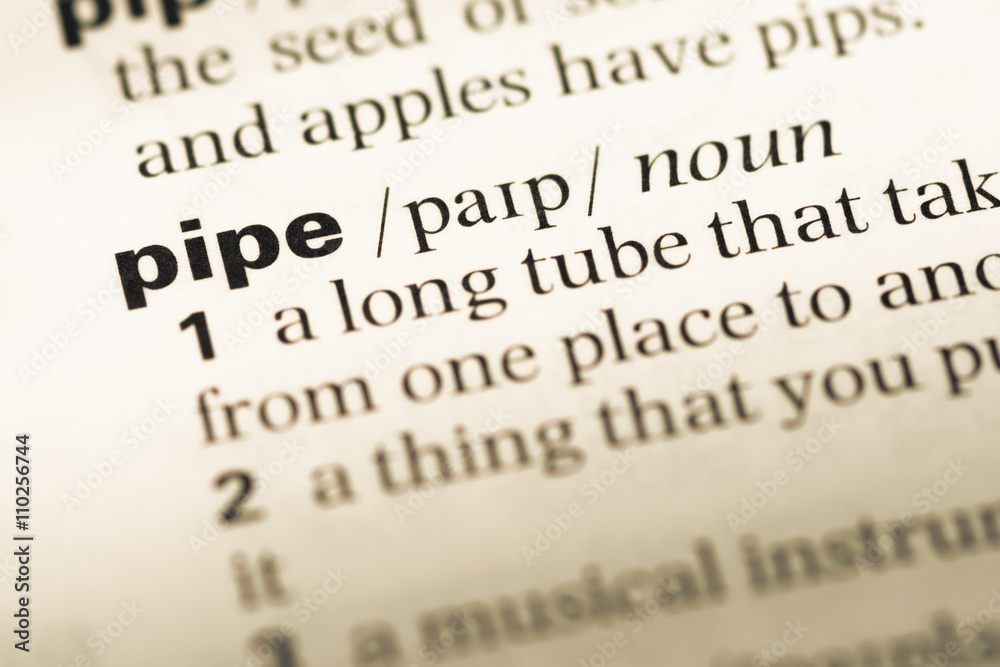 Close up of old English dictionary page with word pipe Close up of old English dictionary page with word pipe